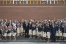 President of Russia's Olympic Committee Alexander Zhukov, fourth right, and Sports Minister Vitaly Mutko, center, pose for a photo with Russia's National Olympic team members outside the Kremlin wall, before a meeting with Russian President Vladimir Putin, in Moscow, Russia, Wednesday, July 27, 2016. At least 105 athletes from the 387-strong Russian Olympic team announced last week have been barred from the Rio Games in connection with the country's doping scandal. (AP Photo/Pavel Golovkin)
