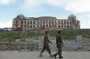 Afghan national army soldiers walk past the palace of the late King Amanullah Khan, which was destroyed during the civil war in early 1990s, in Kabul, Afghanistan, Sunday, April 27, 2014. (AP Photo/Rahmat Gul)