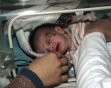 A baby girl, rescued from a building that collapsed during an earthquake, rests in an incubator in a hospital in Ercis