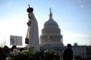 A statue of the Virgin Mary is carried by abortion foes with the US Capitol dome in 2011