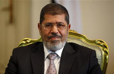 Egypt's President Mursi smiles during meeting with South Korea's presidential envoy and former Foreign Minister Yu at the presidential palace in Cairo