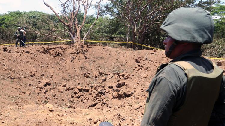 A Nicaraguan soldier checks the site where an alleged meteorite struck, in Managua, on September 7, 2014