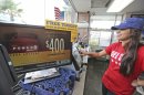 Karen Morales prints out a Powerball lottery ticket for sale to a customer at the Fuel City in Dallas on Wednesday, Sept. 18, 2013. For Wednesday's drawing, Powerball's estimated $400 million jackpot will be the nation's fifth-largest ever. (AP Photo/LM Otero)