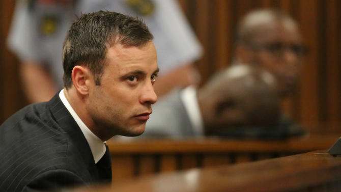 Oscar Pistorius sits in the dock looking in court in Pretoria, South Africa, Friday, Sept. 12, 2014.  Judge Thokozile Masipa found Pistorius guilty of culpable homicide for the shooting death of his girlfriend Reeva Steenkamp. Sentencing procedures will start Oct. 13. (AP Photo/Siphiwe Sibeko, Pool)
