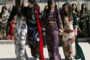 Iraqi students wearing traditional Kurdish clothing celebrate International Women's Day in Arbil in March
