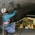 A worker inspects the structure inside the 1.65-kilometer (1-mile) Tsuburano Tunnel on the Tomei Expressway in Yamakitamachi, Kanagawa Prefecture, eastern Japan, Monday, Dec. 3, 2012. Concrete ceiling panels fell onto moving vehicles deep inside a tunnel on another expressway in Japan Sunday, and authorities confirmed nine deaths before suspending rescue work Monday while the roof was being reinforced to prevent more collapses. (AP Photo/Kyodo News) JAPAN OUT, MANDATORY CREDIT, NO LICENSING IN CHINA, FRANCE, HONG KONG, JAPAN AND SOUTH KOREA