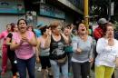 People shout at Venezuelan National Guards during riots for food in Caracas