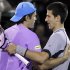 Tommy Haas, left, of Germany, hugs Novak Djokovic, of Serbia, after Haas' 6-2, 6-4 win at the Sony Ericsson Open tennis tournament in Key Biscayne, Fla., Tuesday, March 26, 2013. (AP Photo/Luis M. Alvarez)