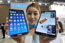 A model holds Samsung's first 'curved' smartphone Galaxy Round at the Electronics and IT Industry Fair in Goyang, north of Seoul, on October 10, 2013