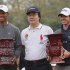 McIlroy of Northern Ireland holds winner's trophy as he poses with Woods of U.S. and Changge after matchplay exhibition event at Jinsha Lake Golf Club in Zhengzhou
