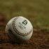 A baseball with the Olympic logo lies on the field during the U.S.-China baseball game at the Beijing 2008 Olympic Games