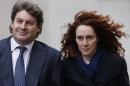 Former News International chief executive Brooks leaves the Old Bailey courthouse with her husband Charlie in London