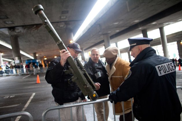 RETRANSMISSION TO CORRECT WEAPON TYPE - Seattle Police Department officers examine an inert surface to air missile launcher brought to the gun buy back program run by the Seattle Police Department on Saturday, January 26, 2013. The city has collected donations totaling nearly $120,000 to pay for a series of gun buyback events. Participants have been asked to unload and secure their weapons in the trunk of their vehicle or in a locked container. (AP Photo/seattlepi.com, Joshua Trujillo) MAGS OUT; NO SALES; SEATTLE TIMES OUT; MANDATORY CREDIT; TV OUT