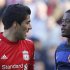 Liverpool's Suarez and Manchester United's Evra look look at each other during their English Premier League soccer match at Anfield in Liverpool