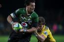 Jacques-Louis Potgieter (L) of the Bulls is tackled by Beauden Barrett of the Hurricanes during the Super 15 Rugby Union match between the Hurricanes vs RSA Bulls at McLean Park in Napier, New Zealand on April 5, 2014