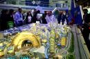 Visitors gather near a scale model of the Mall of the World at the annual Cityscape Global show on September 21, 2014, in the Gulf emirates of Dubai