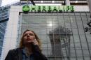 A woman is seen beneath a Herbalife sign in downtown Los Angeles on January 24, 2014