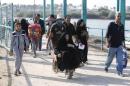Displaced Sunni people fleeing the violence in Ramadi, cross a bridge on the outskirts of Baghdad