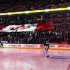 Maple Leafs goalie Reimer stands while the Canadian national anthem is played as fans hold a giant Canadian flag before his team plays the Flyers in their NHL hockey game in Toronto