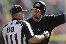 San Francisco 49ers head coach Jim Harbaugh, right, argues with an official during the second quarter of an NFL preseason football game against the Denver Broncos in Denver, Sunday, Aug. 26, 2012. (AP Photo/Joe Mahoney)