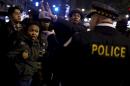 Demonstrators argue with police officers during a protest in response to the fatal shooting of Laquan McDonald in Chicago