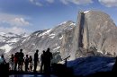 FILE - In this 2005 file photo, visitors view Half Dome from Glacier Point at Yosemite National Park, Calif. Visitors to America's national parks will encounter fewer rangers, find locked restrooms and visitors centers, and see trashcans emptied less often if 5 percent across-the-board cuts are enacted by sequestration. A National Park Service internal memo obtained by The Associated Press compiles a list of cuts in services in parks from Cape Cod to Yosemite. It's the result of an order by Park Service Director John Jarvis in January that asked superintendents to show how they will absorb the funding cuts. (AP Photo/Dino Vournas, File)
