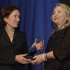 U.S. Secretary of State Hillary Clinton (R) presents the Common Ground Award in honor of slain ambassador to Libya Chris Stevens to his sister Anne Stevens at the Carnegie Institution for Science in Washington