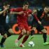 Portuguese forward Cristiano Ronaldo vies with Dutch midfielder Wesley Sneijder (R) and Dutch forward Robin van Persie