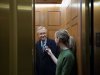 Senate Majority Leader Harry Reid, left, from Nevada, talks with a journalist as the elevator doors close as he departs the Capitol after a vote about the fiscal cliff, on Capitol Hill Tuesday, Jan. 1, 2013 in Washington. The Senate passed legislation early New Year's Day to neutralize a fiscal cliff combination of across-the-board tax increases and spending cuts that kicked in at midnight. (AP Photo/Alex Brandon)