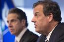 New York Governor Andrew Cuomo, left, listens as New Jersey Governor Chris Christie talks at a news conference, Friday, Oct. 24, 2014 in New York. The governors announced a mandatory quarantine for people returning to the United States through airports in New York and New Jersey who are deemed "high risk." In the first application of the new set of standards, the states are quarantining a female healthcare worker returning from Africa who took care of Ebola patients. (AP Photo/Mark Lennihan)