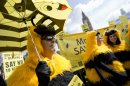 Bee-keepers and apiarists dressed up as bees demonstrate outside the Palace of Westminster as they ramp up their campaign to show public opinion ahead of the European Commission vote on the proposal to ban bee-harming neonicotinoid pesticides, in London, Friday, April, 26, 2013. (AP Photo/Alastair Grant)