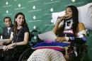 Circus acrobats Julissa Segrera, second from left, of the United States, and Dayana Costa, right, of Brazil, are tearful as Costa reads a statement to members of the media at Spaulding Rehabilitation Hospital, Tuesday, June 17, 2014, in Boston. Eight acrobats were injured during a May 4 performance of the Ringling Bros. and Barnum & Bailey Circus in Providence, R.I., when the apparatus from which they were suspended fell, sending them plummeting to the ground. (AP Photo/Steven Senne)
