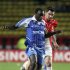 Auxerre's Dennis Oliech challenges Monaco's Thomas Mangani during their French Ligue 1 soccer match in Monaco