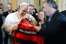 Pope Francis receives a Flamengo soccer jersey with his name on it from soccer coach Zico in Rio de Janeiro, Brazil, Thursday, July 25, 2013. (AP Photo/Luca Zennaro, Pool)