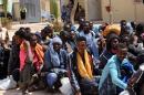 Migrants from sub-Saharan Africa sit at a center for illegal migrants in the al-Karem district of the Libyan port city of Misrata on May 9, 2015