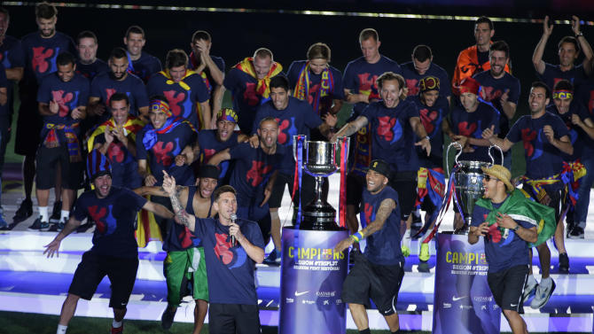 Barcelona&#39;s Lionel Messi, center left, speaks during celebrations at the Camp Nou stadium in Barcelona, Spain Sunday June 7, 2015 after winning the Champions League final soccer match Saturday by beating Juventus Turin 3-1. Barcelona won the triple this season winning the Spanish League title, the Copa del Rey and the Champions League. (AP Photo/Emilio Morenatti)