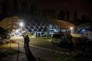 Police on September 28, 2016 stand in front of an air dome housing a refugee shelter in Berlin, where a migrant was shot dead by officers