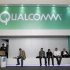People sit next a Qualcomm stand at the Mobile World Congress at Barcelona