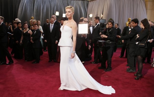 Actress Charlize Theron wearing white Dior Haute Couture column gown arrives at the 85th Academy Awards in Hollywood, California