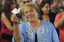 Chilean presidential candidate Michelle Bachelet shows her vote during the presidential election in Santiago