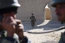 Afghan National Army soldiers patrol the compound of the mosque where Mullah Omar founded the Taliban movement over 20 years ago, in the village of Sangesar