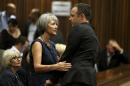 Olympic and Paralympic track star Oscar Pistorius is comforted by a family member during the third day of his trial for the murder of his girlfriend Reeva Steenkamp at the North Gauteng High Court in Pretoria