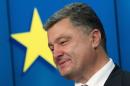 Ukraine's President Poroshenko smiles as he speaks during news conference at EU Council in Brussels