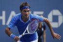 Federer of Switzerland chases down a return to Berlocq of Argentina at the U.S. Open tennis championships in New York