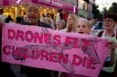 American citizens hold a banner that reads "Drones fly children die" during an anti-war rally in Pakistan on Oct. 5, 2012.