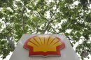 A logo is seen under a canopy of trees at a Shell petrol station in central London