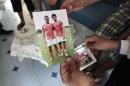 Fethi Selmi shows a photo of her son Nidhal, a youth who was killed during fighting in Syria, during an interview with Reuters in Sousse