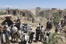 Afghan villagers gather at a house destroyed in an apparent NATO raid in Logar province, south of Kabul, Afghanistan on Wednesday, June, 6, 2012. Afghan officials and residents say a pre-dawn NATO airstrike aimed at militants in eastern Afghanistan killed civilians celebrating a wedding, including women and children. (AP Photo/Ihsanullah Majroh)