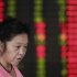 An investor looks at the stock price monitor at a private securities company in Shanghai, China, Tuesday Sept. 25, 2012. Asian stock markets were held in check Tuesday by a host of concerns about the global economy. (AP Photo/Eugene Hoshiko)