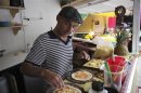Former freelance photographer Xavi Berdala of Barcelona, prepares pizza at his pizza stall in Tepoztlan